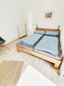 a bedroom with a large bed with blue pillows at Ferienwohnung Gartenblick - Idylle am Travetal in Bad Oldesloe