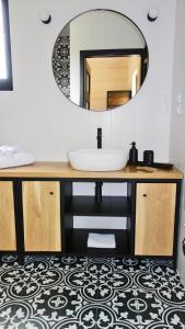 a bathroom with a sink and a mirror at Dzikie Lisko - Apartament z tarasem in Lesko