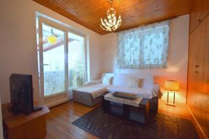 a living room with a white couch and a tv at Apartment Angela in Malinska