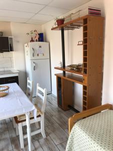 a kitchen with a table and a white refrigerator at Departamento en Olavarría in Olavarría