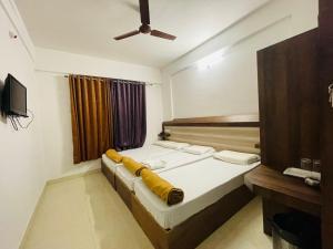 a bedroom with a bed and a ceiling fan at B Six Hotel in Bangalore