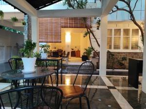 a patio with tables and chairs in a building at Villa Papillon in Phnom Penh