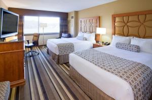 a hotel room with two beds and a flat screen tv at Crowne Plaza Minneapolis West, an IHG Hotel in Plymouth