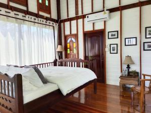 a bedroom with a large bed with a window at Destiny Home Stay