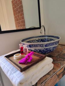 a bathroom counter with a sink and a large bowl at Destiny Home Stay 