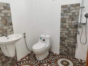 a bathroom with a toilet and a sink at Destiny Home Stay 