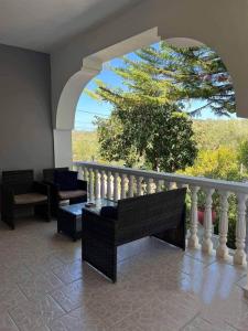 a living room with a balcony with a table and chairs at Olive de Villa in Áyios Dhimítrios