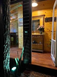 a view of a bathroom in a log cabin at La Casa Del Arbol con pileta privada in Capilla del Señor