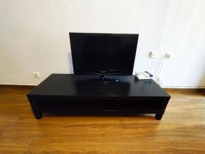 a black table with a television on top of it at Sunny flat with huge terrace! Close downtown! in Alicante