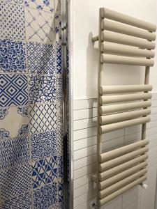 a bathroom with blue and white tiles and a shower at Elementi Luxury House in Otranto