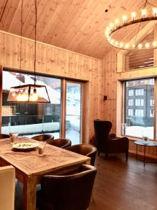 a dining room with a wooden table and chairs at Fyri Tunet Hemsedal in Hemsedal