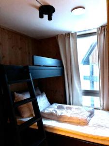 a bedroom with a bunk bed and a window at Fyri Tunet Hemsedal in Hemsedal