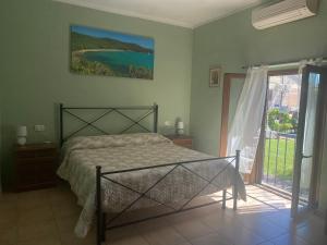 a bedroom with a bed and a large window at CASA VACANZE ARCOBALENO in Grosseto +23 photos