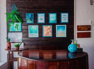 a room with a wooden wall with pictures on it at Pousada Natal in Morro de São Paulo