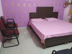 a bedroom with a bed and two chairs at DooN Resort & Farmhouse stay in Dehradun