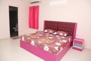 a bedroom with a purple bed with a purple headboard at The best villa stay- family friendly in Coimbatore