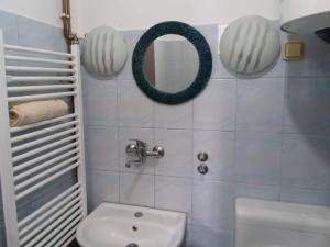a bathroom with a white toilet and a mirror at Apartmani Emir in Visoko +6 photos