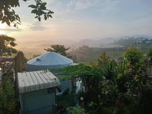 a white tent in a garden with a view at โดม มองโก แสงเพ็ญ in Khao Kho