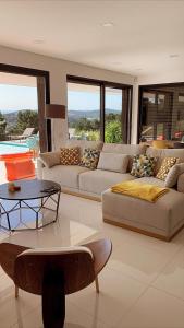 uma sala de estar com um sofá e uma mesa em Villa White Lagoon, 6 guests, 2 bathrooms, heated private pool, amazing view, fully Equiped ! em Alfeizerão