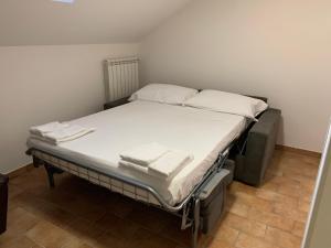 a hospital bed with white sheets and pillows on it at Oasi del patricano, Patrica in Patrica