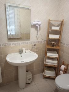 uma casa de banho com um lavatório, um espelho e um WC. em B&B COLLE TARIGNI em Manoppello