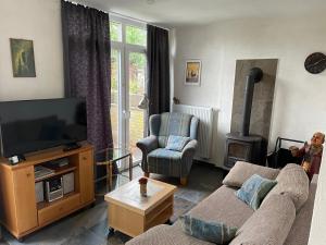 a living room with a couch and a flat screen tv at Ferienwohnung Thöne in Horstmar