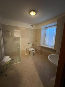 a bathroom with a toilet and a sink and a shower at Locanda Aquila Nera in Aquiléia