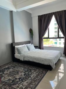 a bedroom with a bed and a large window at Casahome by Irdina Meru- 8pax -10pax in Ipoh