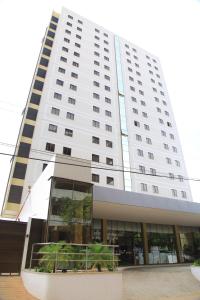 a large white building with a large window at Stay Inn Hotel in Imperatriz