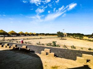 a group of huts in the middle of a field at RANN STAR VILLAGE STAY in Dhordo +35 photos