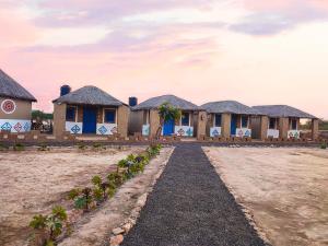 a row of houses with blue doors at RANN STAR VILLAGE STAY in Dhordo +23 photos