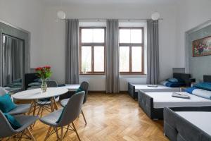 a living room with a couch and a table and chairs at Near the Royal Castle in Krakow