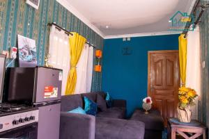 a living room with blue walls and a couch at Zahi Home, your cosy tiny home experience in Naro Moru