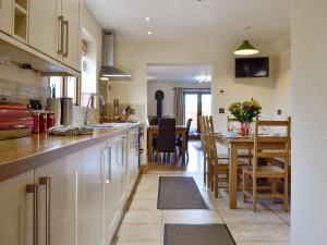 uma cozinha com uma mesa e uma sala de jantar em King Offa Lodge - Uk10261 em Penrhôs