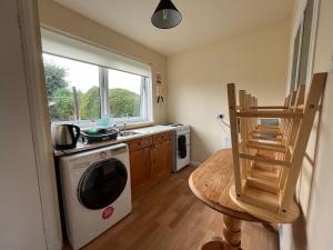 a kitchen with a sink and a washing machine at Inverness House in Inverness