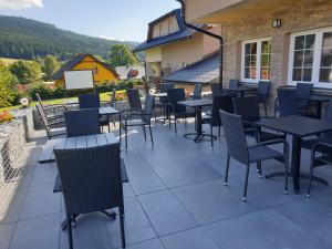 a group of tables and chairs on a patio at Hotel Park in Ostružná