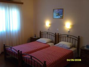 a bedroom with two beds and a window at Elisabeth Villas in Kerveli