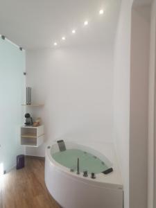 a white bath tub in a white room at Maqueda Mood in Palermo