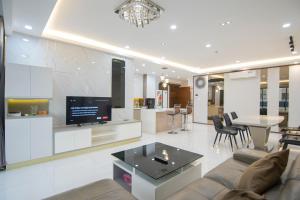 a living room with a couch and a tv at Luxury Gold Apartment 86 -Rooftop Pool Central City in Ho Chi Minh City