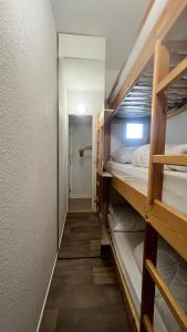 a corridor of a room with bunk beds at la foux d'allos au pied des pistes in La Foux