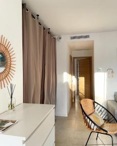 a kitchen with a white counter and two chairs at Résidence Casarella Lama in Lama