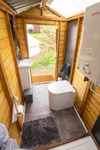 a small bathroom with a toilet and a sink at Roaches Retreat Eco Glampsite - Hen Cloud View Bell Tent in Upper Hulme