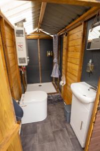 a small bathroom with a toilet and a sink at Roaches Retreat Eco Glampsite - Hen Cloud View Bell Tent in Upper Hulme