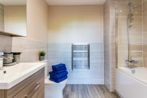a bathroom with a sink and a toilet and a shower at The Arc - Stunning Luxury 2 Bed Duplex Apartment in Newcastle upon Tyne +49 photos