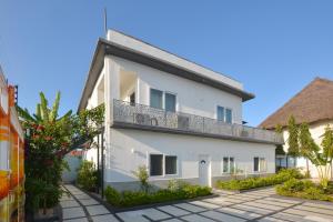 a white building with a balcony at Bless Villa Apartment in Kiwengwa