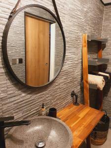 a bathroom with a sink and a mirror at ô Langevin , Logement avec véhicule in Saint-Joseph