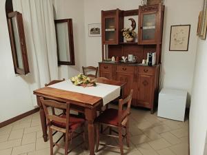 a dining room with a wooden table and chairs at Residenza Schinardi in Oristano