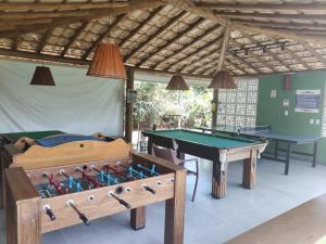 a room with two ping pong tables and a bed at Apto na Praia de Itacimirim H in Itacimirim