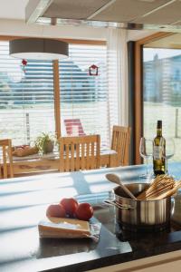 a kitchen with a counter with tomatoes and wine glasses at Appartements Christine in Bezau