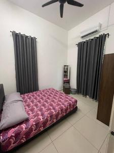 a bed in a room with black curtains at Bungalow Homestay Jasin in Melaka